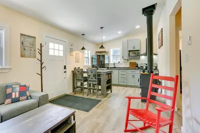 a kitchen and living room with a couch and a table at Secluded Poconos Cabin 75 Acres and Fire Pit! in East Stroudsburg
