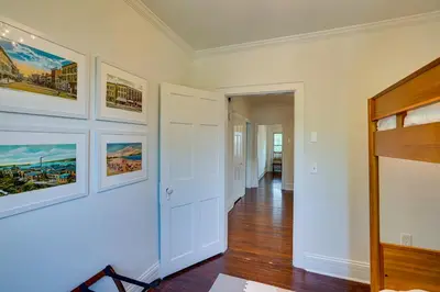 a room with white walls and a hallway with paintings at Historic Home in Coxsackie with Hudson River Views! in Coxsackie