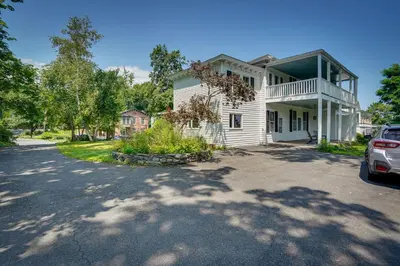 a house with a car parked in the driveway at Historic Home in Coxsackie with Hudson River Views! in Coxsackie