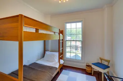 a bedroom with two bunk beds and a window at Historic Home in Coxsackie with Hudson River Views! in Coxsackie