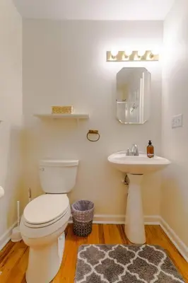 a bathroom with a toilet and a sink at Saratoga Serenity: Charming Rental Nearby Downtown in Saratoga Springs