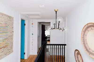 a dining room with a chandelier and a hallway at The Norsdale plus CMYK Motel on 10 acres in Phoenicia in Phoenicia