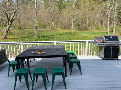 a picnic table and chairs on a deck with a grill at The Norsdale plus CMYK Motel on 10 acres in Phoenicia in Phoenicia