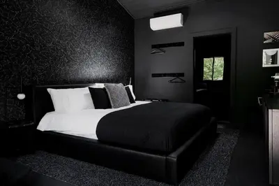 a black bedroom with a bed and a window at The Norsdale plus CMYK Motel on 10 acres in Phoenicia in Phoenicia