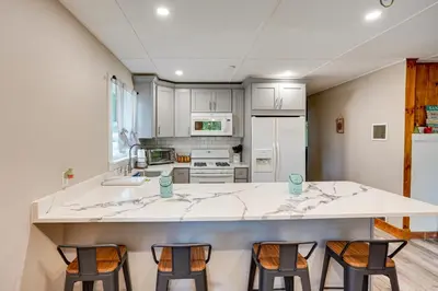 a kitchen with a large island with four chairs at Monterey Haven Less Than half Mi to Lake Garfield with Kayaks in Monterey