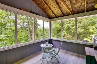 a table and chairs in a room with windows at Monterey Haven Less Than half Mi to Lake Garfield with Kayaks in Monterey