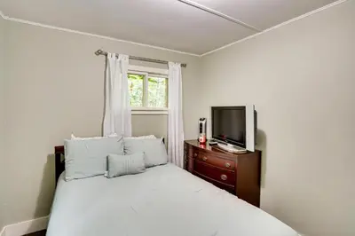 a bedroom with a bed with a tv and a window at Monterey Haven Less Than half Mi to Lake Garfield with Kayaks in Monterey