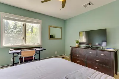 a bedroom with a bed and a desk and a television at Warwick Vacation Rental with Private Yard and Fire Pit in Warwick