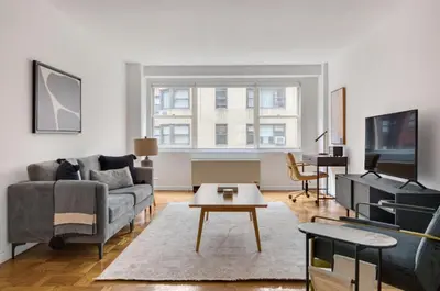 a living room with a couch and a table at UES 1br w elevator doorman nr Central Park NYC-1186 in New York