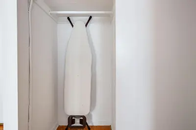 a white dress hanging on a wall in a closet at UES 1br w elevator doorman nr Central Park NYC-1186 in New York