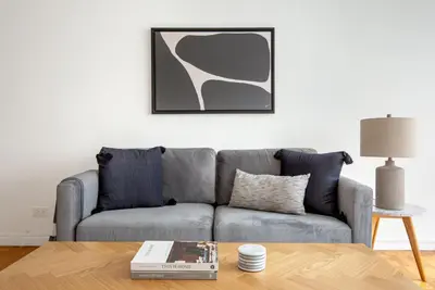 a living room with a couch and a table at UES 1br w elevator doorman nr Central Park NYC-1186 in New York