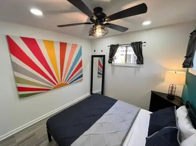 a bedroom with a bed and a ceiling fan at Wally's Cottage in Hawley