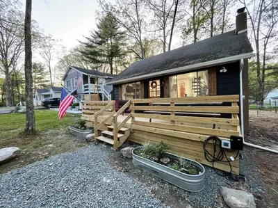 a house with an american flag in front of it at Wally's Compound in Hawley