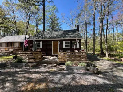 a small house with a fence in front of it at Wally's Cabin in Hawley