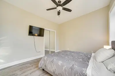 a bedroom with a bed and a flat screen tv at Walk to Dtwn and Waterfront Roomy Troy Apt in Troy