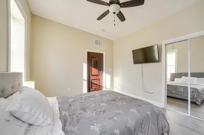 a bedroom with a bed and a ceiling fan at Walk to Dtwn and Waterfront Roomy Troy Apt in Troy
