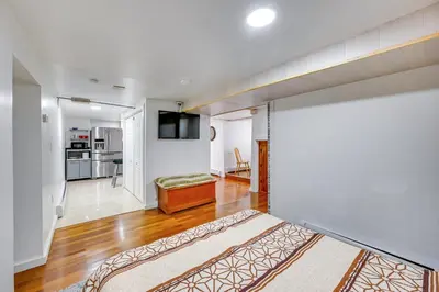a bedroom with a bed and a living room at East Hartford Studio about 4 Mi to Downtown Hartford! in East Hartford