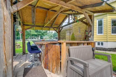 a patio with a wooden bar with two chairs at East Hartford Studio about 4 Mi to Downtown Hartford! in East Hartford
