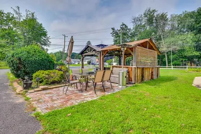 a gazebo with a table and chairs in a yard at East Hartford Studio about 4 Mi to Downtown Hartford! in East Hartford