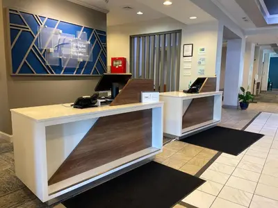 a lobby with two reception desks in a office at Holiday Inn Express and Suites Montgomery by IHG in Montgomery