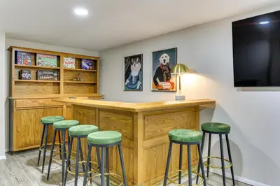a bar with green stools in a room at Sauna, Fire Pit Spacious and Serene Poconos Getaway in Canadensis