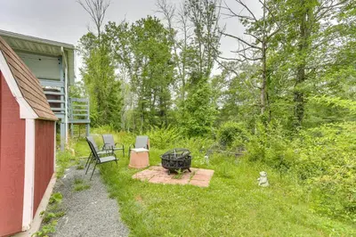 a backyard with a grill and chairs and a fire pit at Sauna, Fire Pit Spacious and Serene Poconos Getaway in Canadensis