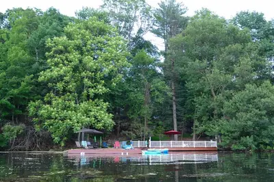 a small island in the middle of a body of water at 3 Acre Lake Paradise Swimming Pool & Jacuzzi HotTub! in Hopatcong