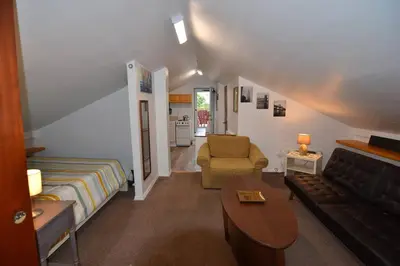 a living room with a bed and a couch at Cozy Alcove Studio Apt w Outdoor deck w NYC Views in Jersey City