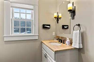 a bathroom with a sink and a mirror at Brook Bound Inn in Wilmington