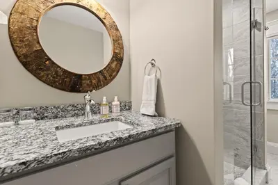 a bathroom with a sink and a mirror at Brook Bound Inn in Wilmington