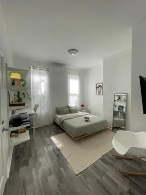 a bedroom with a bed and a desk in it at Cozy Private studio in Bushwick in Brooklyn