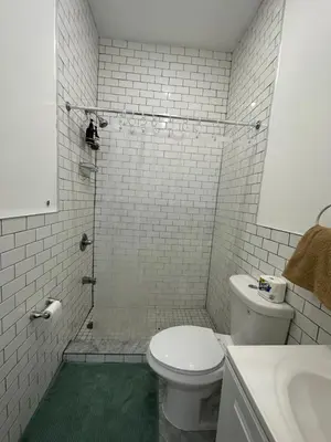 a white bathroom with a toilet and a sink at Cozy Private studio in Bushwick in Brooklyn