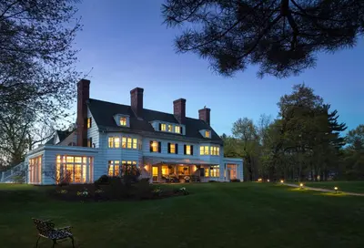 a large house with many windows on a lawn at Four Chimneys Inn in Bennington