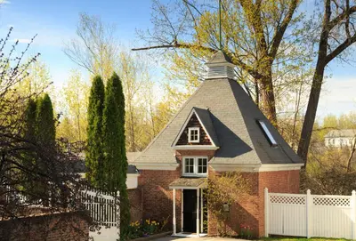 a small brick house with a steep roof at Four Chimneys Inn in Bennington