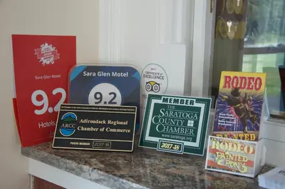 a group of signs sitting on top of a counter at Sara Glen Motel - Saratoga Springs-Glens Falls in Saratoga Springs