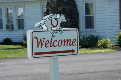 a welcome sign in front of a house at Sara Glen Motel - Saratoga Springs-Glens Falls in Saratoga Springs
