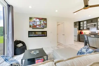 a living room with a couch and a table at Lakefront Catskills Container Home Private Lake in Swan Lake
