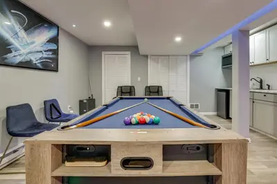 a room with a pool table with balls on it at Hot Tub and Lake Access Spacious Tobyhanna Home in Tobyhanna