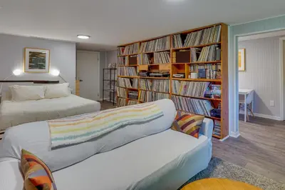 a bedroom with two beds and a book shelf filled with books at Pet-Friendly Staatsburg Studio - Near State Park in Staatsburg