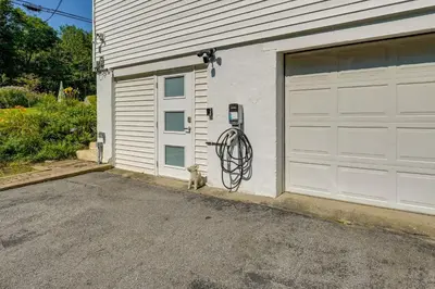 a cat sitting in front of a garage at Pet-Friendly Staatsburg Studio - Near State Park in Staatsburg