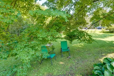 two chairs sitting in the grass under a tree at Pet-Friendly Staatsburg Studio - Near State Park in Staatsburg