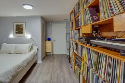 a bedroom with a bed and a book shelf filled with books at Pet-Friendly Staatsburg Studio - Near State Park in Staatsburg