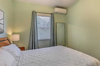 a bedroom with a white bed and a window at Spacious Lakefront House With a Private Dock in Hopatcong