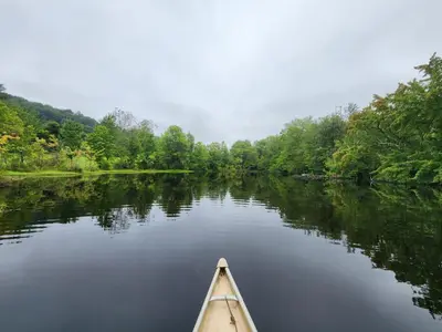 a kayak on a river with trees in the background at 13-Acre Private Estate, Private Lake, Private Golf Range, Private Forest & Hiking Trails in Ross Corner