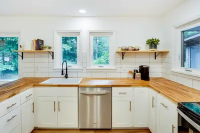 a kitchen with white cabinets and a sink at Fully Remodeled Saugerties Retreat on 7 Acres! in Saugerties