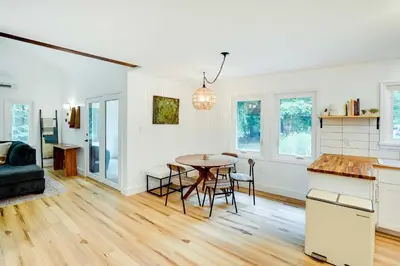 a kitchen and living room with a table and chairs at Fully Remodeled Saugerties Retreat on 7 Acres! in Saugerties