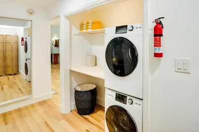 a laundry room with a washer and dryer on a wall at Fully Remodeled Saugerties Retreat on 7 Acres! in Saugerties