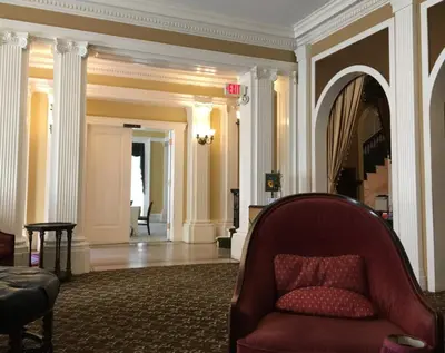 a living room with a red couch in a building at The Stockade Inn in Schenectady