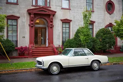 a white car parked in front of a house at The Stockade Inn in Schenectady