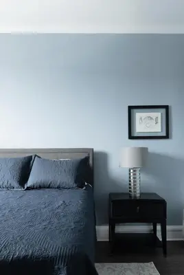 a bedroom with a bed and a lamp on a table at The Stockade Inn in Schenectady